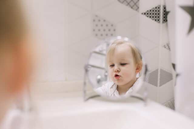 little funny girl brushing teeth washing hands bathroom reflection mirror
